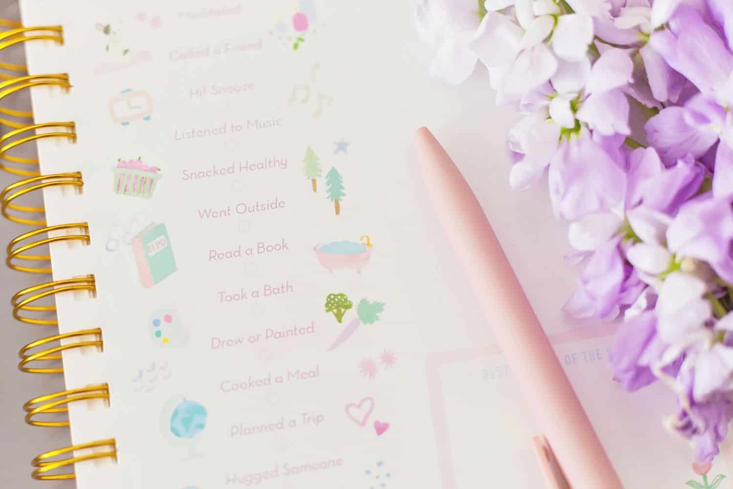 Rewards for a job well done on a cute notebook with some lilac flowers