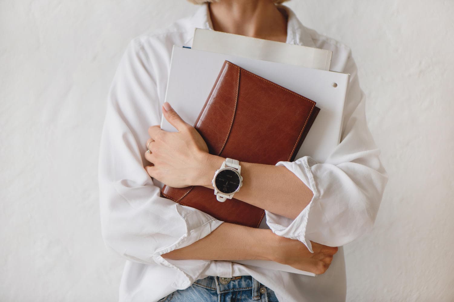 Business woman holding binders and a planner